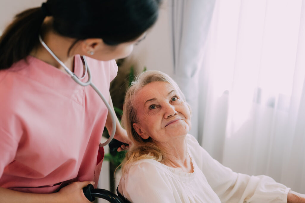 Happy senior woman talking with female caregiver